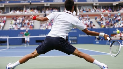 Novak Djokovic returns a shot against Sam Querrey during their US Open third round match on Saturday. Matt Rourke / AP / August 30, 2014 ,