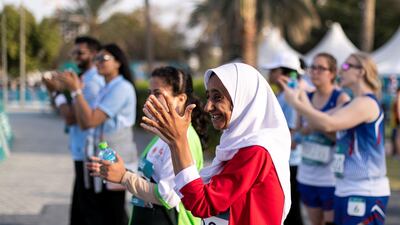 Teammates cheer the runners at the athletics competition at Dubai Police Academy Stadium. Reem Mohammed / The National