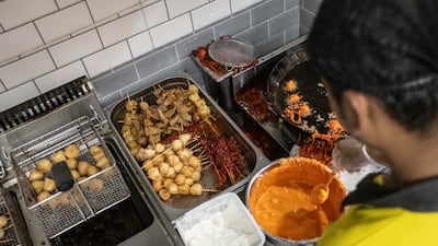 Food is prepared inside a small kitchen