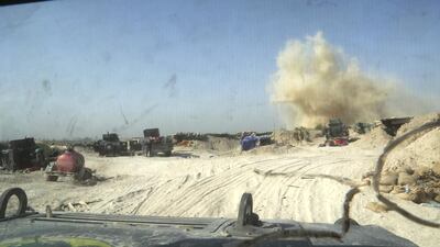 In this picture taken through the windshield of an Iraqi army armoured vehicle, smoke rises near Iraqi counterterrorism forces after the firing of a mortar shell by ISIL in the Nuaimiya neighborhood of Fallujah on Wednesday. Khalid Mohammed/AP Photo