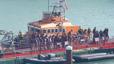 Migrants arrive in Dover, Kent, after a small boat was intercepted the English Channel. PA