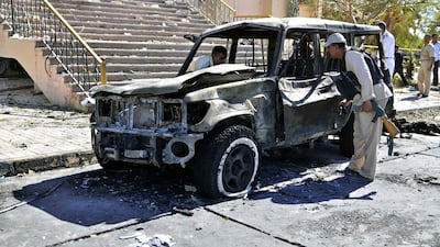 Egyptian security forces inspect the site of a suicide car bombing on security headquarters in the southern Sinai town of El Tor. Mostafa Darwish / AP