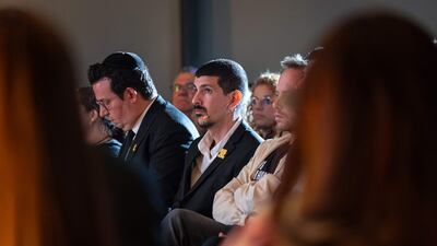 Freed Israeli hostage Or Levy, centre, sits with the audience at an event before sharing his experiences, in Glenhazel, near Johannesburg, South Africa. AFP