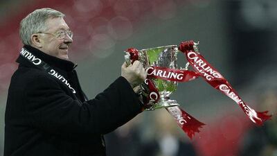 Ferguson holds the Carling Cup on Sunday, the 42nd trophy of his managerial career.