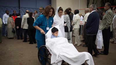 Eight-year-old Alyaz Merali, who received two gunshot wounds during the attack on the Westgate mall, takes part in the funeral on Wednesday of his mother and 15-year-old sister, who were both killed in the attack. Uriel Sinai / Getty Images