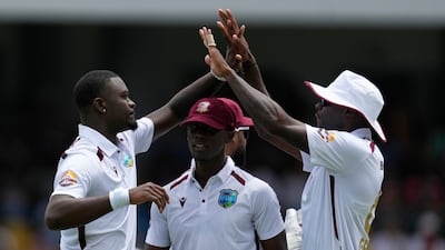 West Indies' Jayden Seales, left, celebrates with teammates after dismissing Australia's Josh Inglis during day one of the first Test match in Barbados. AP