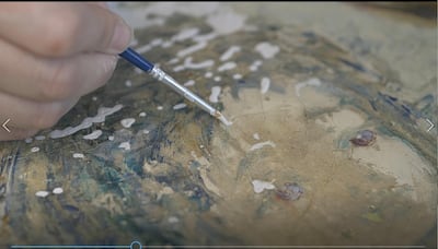 A close up shot of a conservator filling in the paint gaps in Amin Sfeir's 'Little Girl' from 1970. Beirut Museum of Art