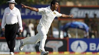 Sri Lanka's Nuwan Kulasekara celebrates taking the wicket of Pakistan's captain Mohammad Hafeez during the third day of their first test match in Galle.
