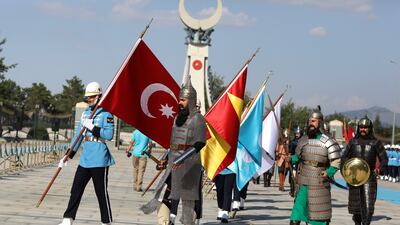 Honour guard members representing former Turkish states walk after a ceremony for Saudi Crown Prince Mohammed bin Salman shake hands during a welcoming ceremony, in Ankara. AP