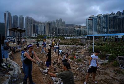 People clean debris from Typhoon Mangkhut on the waterfront in Hong Kong. Vincent Yu / AP Photo