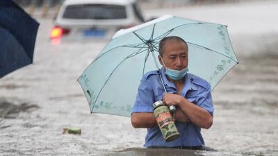 A man wades along a street in Zhengzhou, central China.