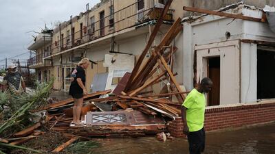 People walk through the wreckage of a building after the arrival of Hurricane Michael in Panama City, Florida. EPA