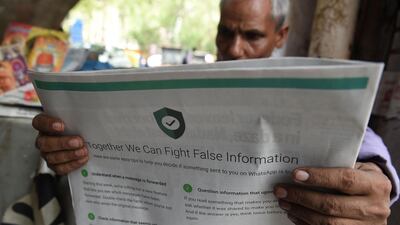 An Indian newspaper vendor reading a newspaper with a full back page advertisement from WhatsApp intended to counter fake information, in New Delhi last July after fake information sparked mob lynching attacks across the country. AFP
