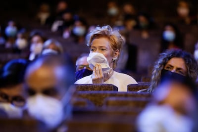 Actress Tilda Swinton wears a mask as she sits in the auditorium during the opening ceremony of the 77th Venice Film Festival in Venice, Italy. AP Photo