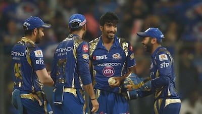 Mumbai Indians cricketer Jasprit Bumrah, second right, is congratulated by teammates after taking the wicket of Sunrisers Hyderabad cricketer Rashid Khan during the 2017 Indian Premier League (IPL) Twenty20 cricket match between Mumbai Indians and Sunrisers Hyderabad at the Wankhede Stadium in Mumbai on April 12, 2017. Indranil Mukherjee / AFP
