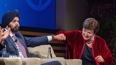 The World Bank's Ajay Banga and the IMF's Kristalina Georgieva fist-bump during a panel discussion in Marrakesh. EPA