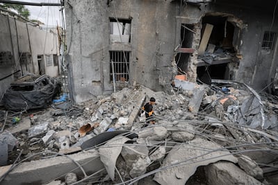 A Palestinian boy inspects the damage to the hospital. Reuters
