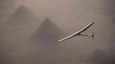 Swiss pilot Andre Borschberg steers Solar Impulse 2 over the pyramids of Giza on Wednesday before landing in Cairo, Egypt, on its solar-powered flight around the world. From there, it’s on to Abu Dhabi and into the record books. Jean Revillard / Solar Impulse 2 via Reuters