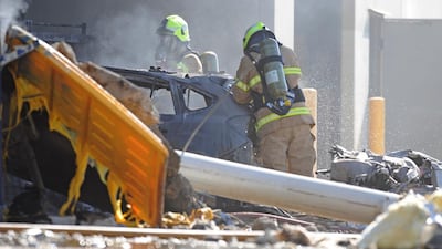 Emergency services workers at the scene of the plane crash in Essendon, Melbourne. Joe Castro / EPA