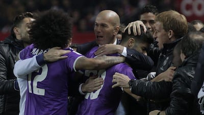 Real Madrid manager Zinedine Zidane celebrates with his players after Marco Asensio scores against Sevilla in the Copa del Rey on Thursday night. Angel Fernandez / AP Photo