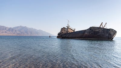 The British-made cargo ship, which ran aground near Haql in 1978, now sits half-submerged in the water. Reem Mohammed / The National