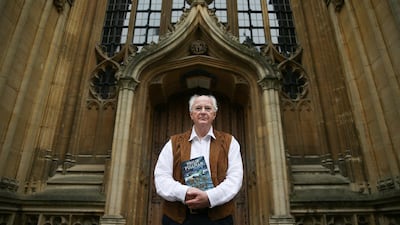 British author Philip Pullman poses with a copy of 'La Belle Sauvage: The Book of Dust Volume One' at the Bodleian Libraries, in Oxford, southern England. AFP