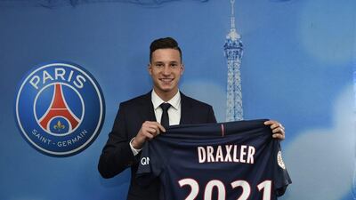 Julian Draxler poses with the PSG jersey at a news conference to announce his four-and-a-half year contract with the French club on January 3, 2017. EPA handout