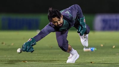 Pakistan captain Mohammad Rizwan dives to catch a ball during a practice session. AFP