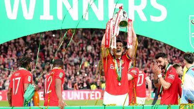 Manchester United's Harry Maguire lifts the League Cup trophy. PA