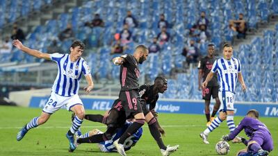 Karim Benzema and Ferland Mendy of Real Madrid are challenged by Aritz Elustondo and Robin Le Normand of Real Sociedad. Getty Images