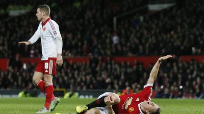 Manchester United's Bastian Schweinsteiger holds his leg after appearing to sustain an injury in a collision with Sheffield United's Chris Basham. Jason Cairnduff / Action Images via Reuters