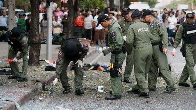 Thai police inspect a bomb site in Bangkok. Three minor blasts rattled the Thai capital, leaving five wounded, including an Iranian, who police say is the suspect.