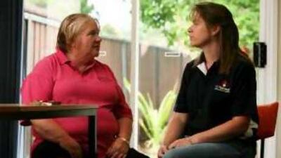 Naomi Hall, right, and June Wells talk about their economic problems in the St Thomas's Anglican Church in Cranebrook, Sydney.
