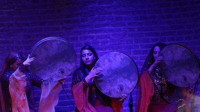 Sarmast musical group members play the daf at the concert.