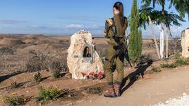 An Israeli soldier pays tribute at a memorial site near Nahal Oz, in southern Israel, to mark the third anniversary of the October 7 attack. AFP