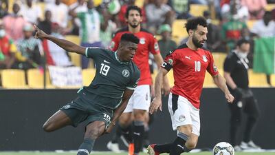 Egypt's Mohamed Salah, right, and Nigeria's Taiwo Awoniyi fight for the ball during the African Cup of Nations Group D soccer match between Egypt and Nigeria in Garoua, Cameroon, Tuesday, Jan. 11, 2022. (AP Photo / Footografiia)