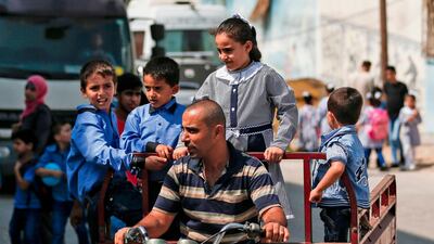 Pupils are driven to a school run by the United Nations Agency for Palestinian Refugees (UNRWA) in Gaza City on August 29, 2018. AFP