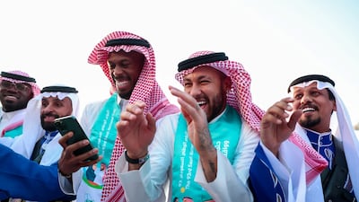 Brazilian football star Neymar in traditional Saudi dress celebrates Saudi Arabia's 93rd National Day with fellow members of Riyadh's Al Hilal Football Club. Reuters