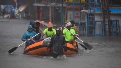 Tamil Nadu rescue workers move residents to safety during heavy rain in Chennai. EPA