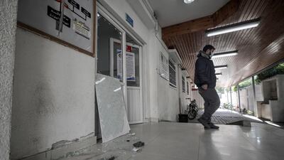 A person inspects the damaged Al Dora hospital for children near a street that Israel reportedly attacked after Palestinian militants fired rockets at Israel, in the east of Gaza city. EPA