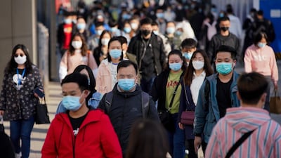 Commuters wear protective masks as they exit a train at a subway station during Monday rush hour on April 13, 2020 in Beijing, China. Getty