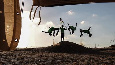 Palestinian youths practice their parkour skills at the Israel-Gaza border in the southern Gaza Strip. Said Khatib / AFP
