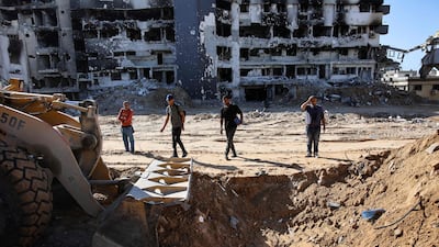 A bulldozer is used to search for mass graves at Al Shifa Hospital in Gaza city this month. AFP