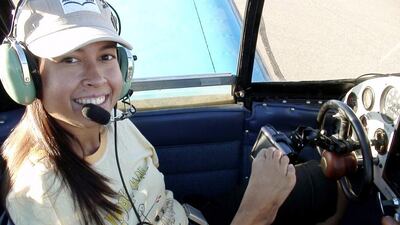 The UAE University team hope that their patent for a 'no-hands' steering system for cars will benefit people such as Jennfier Cox, above, who, despite having no arms, has learned to fly a plane. Wam