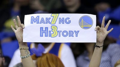 A Golden State Warriors fan holds up a sign during the first half of an NBA basketball game between the Warriors and the Memphis Grizzlies in Oakland, California, Wednesday, April 13, 2016. The Warriors had 72 wins heading into their final regular-season game, the same number of wins as the 1995/96 Chicago Bulls. (AP Photo/Marcio Jose Sanchez)
