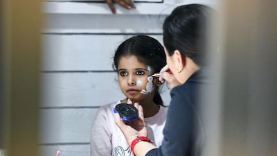 A young girl gets her face painted at the Winter Wonderland event on the Maryah Island waterfront promenade.