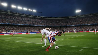 Real Madrid's Gareth Bale battles for the ball with Atletico Madrid's Juanfran on Tuesday night in the Champions League quarter-final first leg. Juan Medina / Reuters