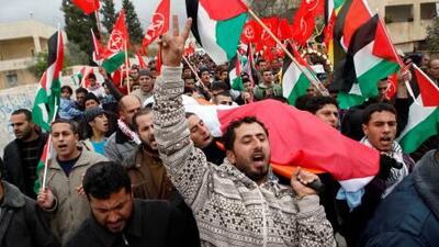 Palestinians carry the body of Jawaher Abu Rahmah during her funeral in the West Bank village of Bilin yesterday.
