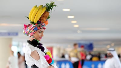 A model sports a fruity hat for the Dubai World Cup. Chris Whiteoak / The National