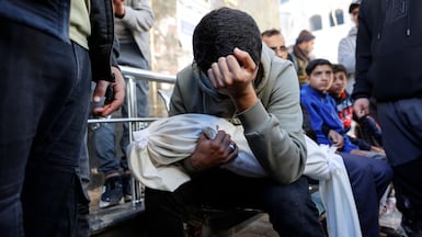 A Palestinian carries the body of Ahmed Al Nader, his five-month-old brother, who was reported to have been killed on Friday along with relatives by Israeli shelling in the Tuffah neighbourhood of Gaza city. AFP